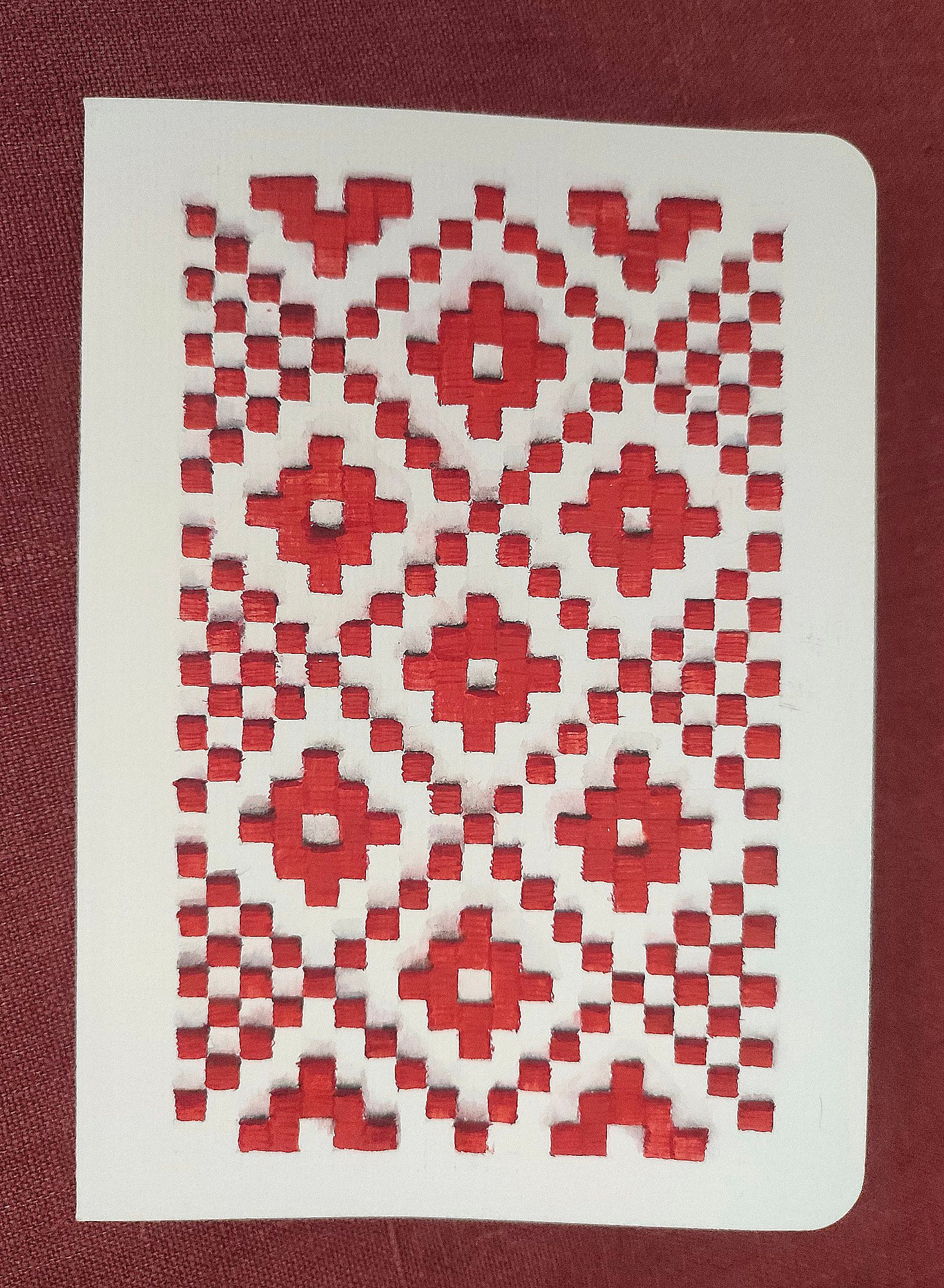 A red Lithuanian motif beautifully represented in a watercolor style on the front of a birthday card.
