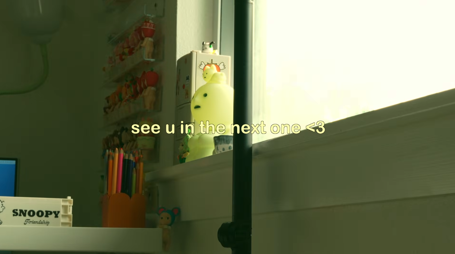 A still from the YouTube video linked underneath this image. Cute characters and art supplies sit in and around a windowsill. The text in the middle says "see u in the next one".