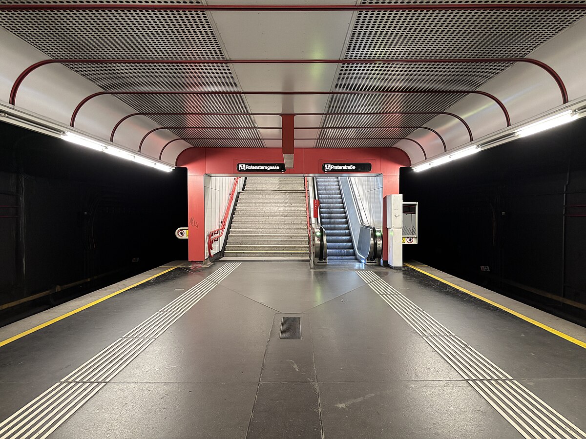 image of an underground subway station looking towards a set of stairs beside an escalator