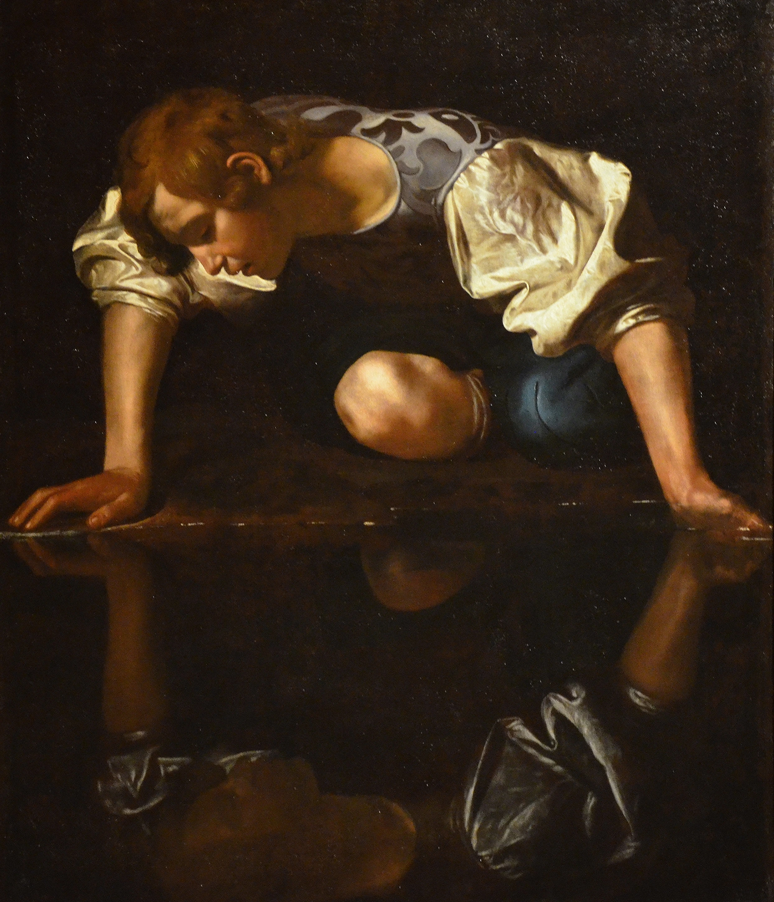 Narcissus at the Source (c.1597-1599). Oil and chiaroscuro on canvas, 110 x 92 cm (43.3 x 36.2 in). Galleria Nazionale d'Arte Antica, Rome. Wikipedia
