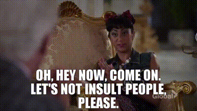 An older man in suit and bowtie sitting on a glamorous couch with a younger woman in a blue dress. He is clapping his hands on his thighs and saying: oh hey now come on.let's not insult people please