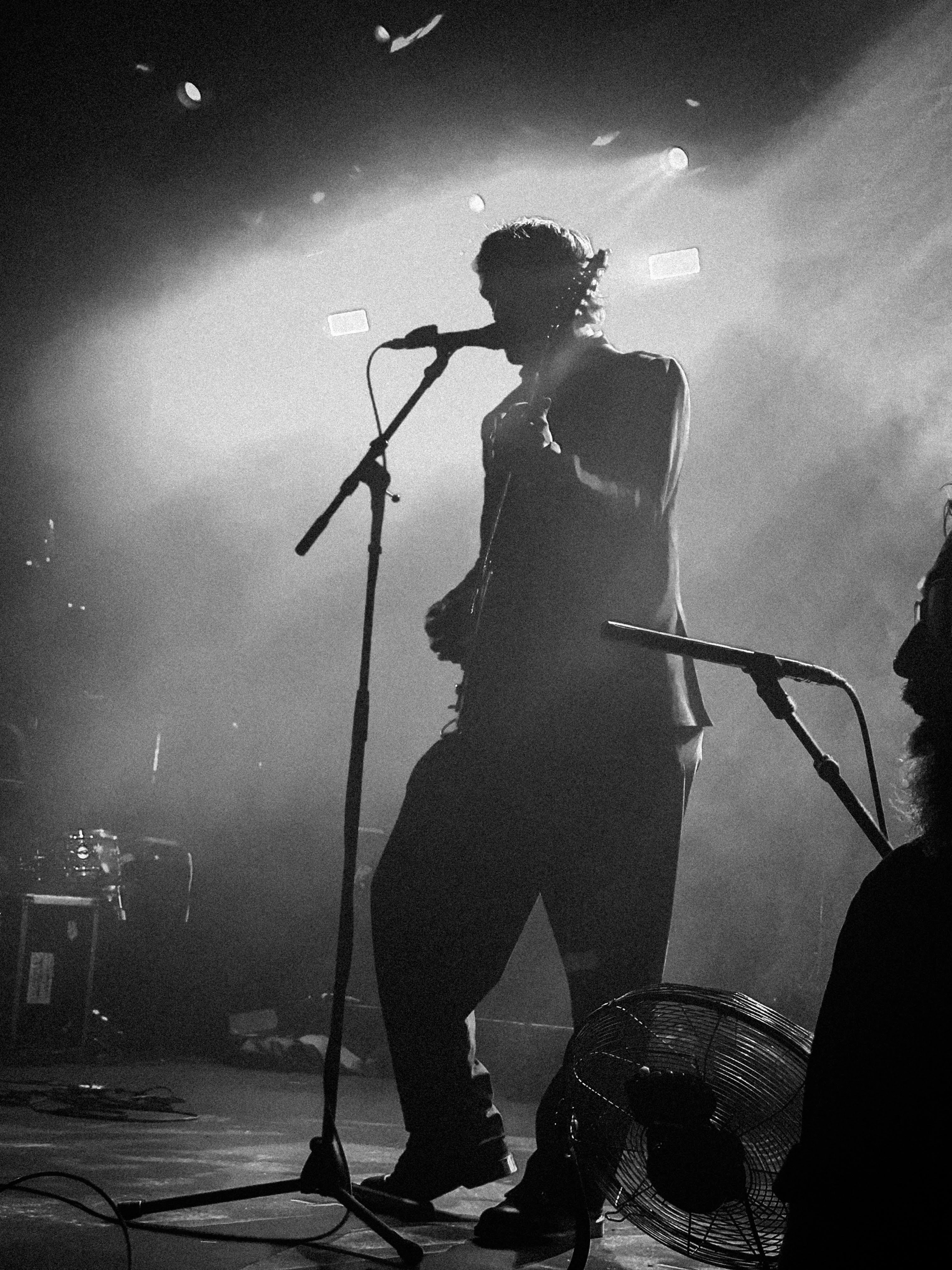 extremely crunchy black and white photograph taken of static dress guitarist vin weight performing on stage. taken by myself.
