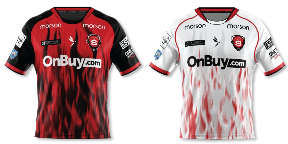 The home jersey is red with black flames rising from the bottom hem, and black sleeves and red trim. The away jersey is white with red flames rising from the bottom hem, and white sleeves and red and black trim.