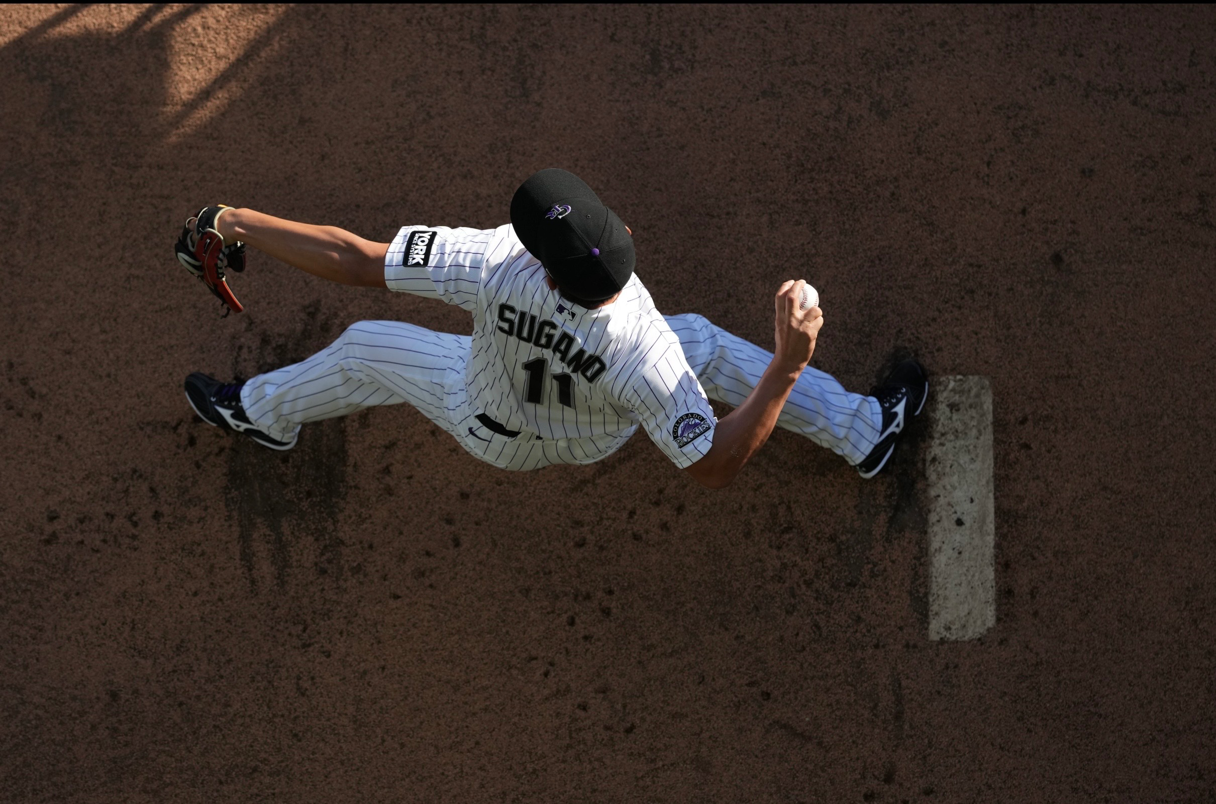 Tomoyuki Sugano warms up at Coors Field.