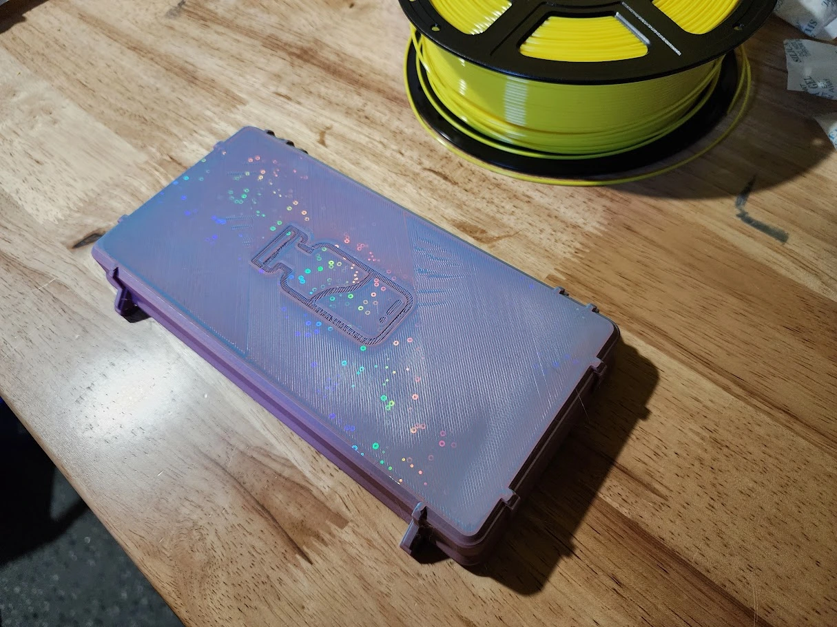 A 3D printed rainbow soft purple gradient vial case on a workbench