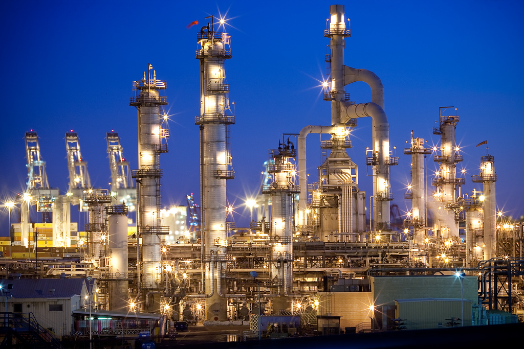 An oil refinery illuminated at night