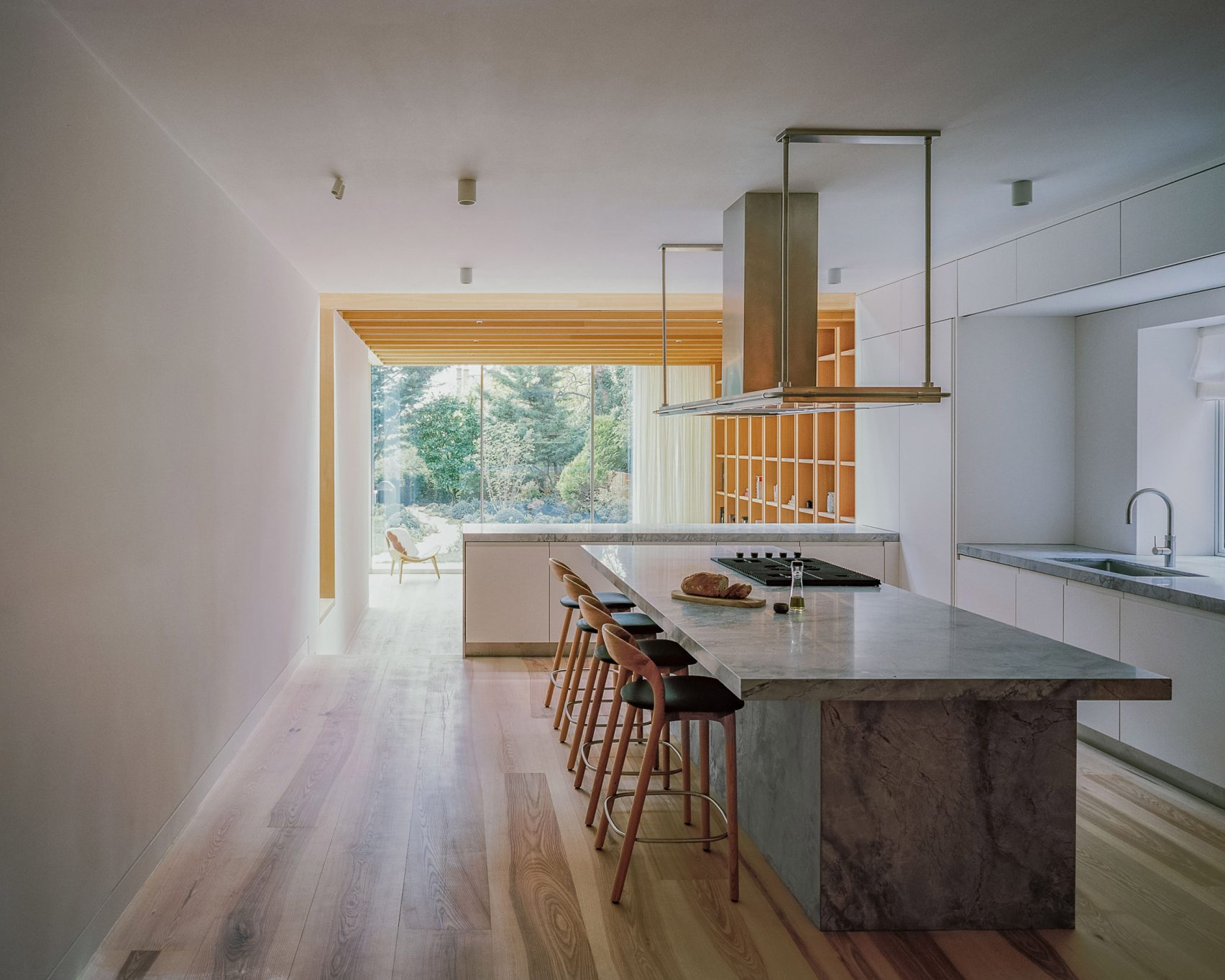 Mature trees and sheer curtains provide privacy to the room