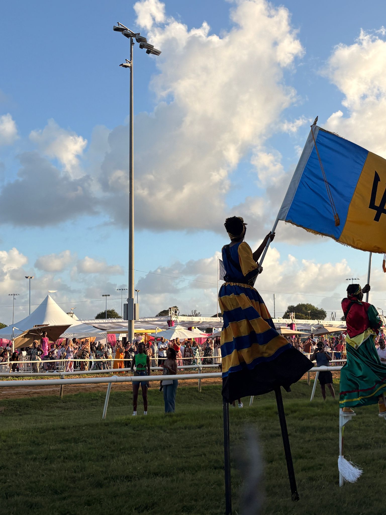 Good Cup parade - stilt walkers waving the flag of Barbados 