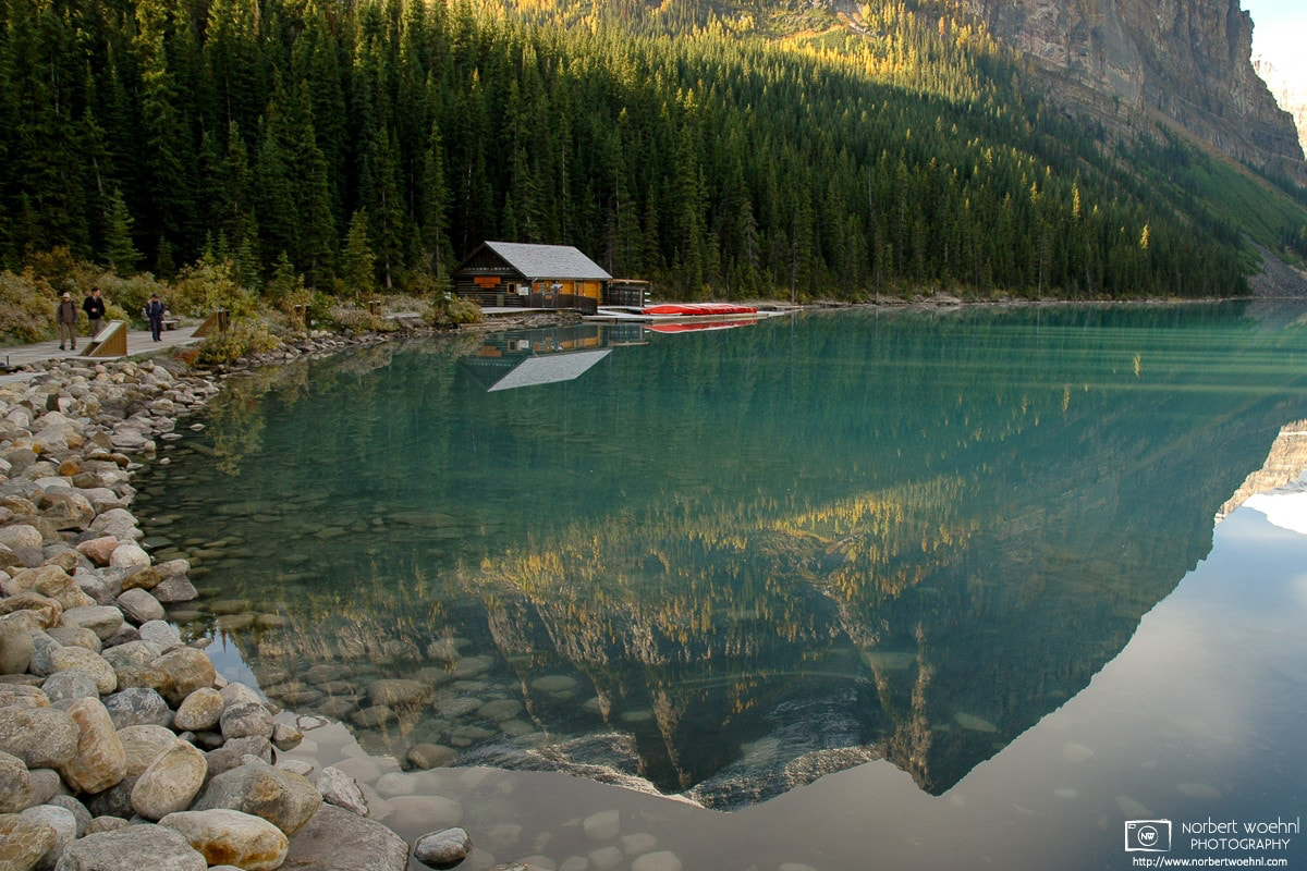 The boathouse and an adjacent peak are reflected off the crystal-clear surface of Lake Louise in Banff National Park, Alberta, Canada. © 2005 Norbert Woehnl Photography.
