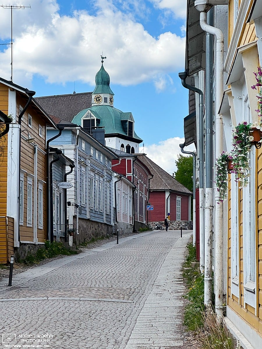 Walking up Kirkkokatu in the historic district of Porvoo, Finland. Porvoo Cathedral is visible in the back. © 2026 Norbert Woehnl Photography.