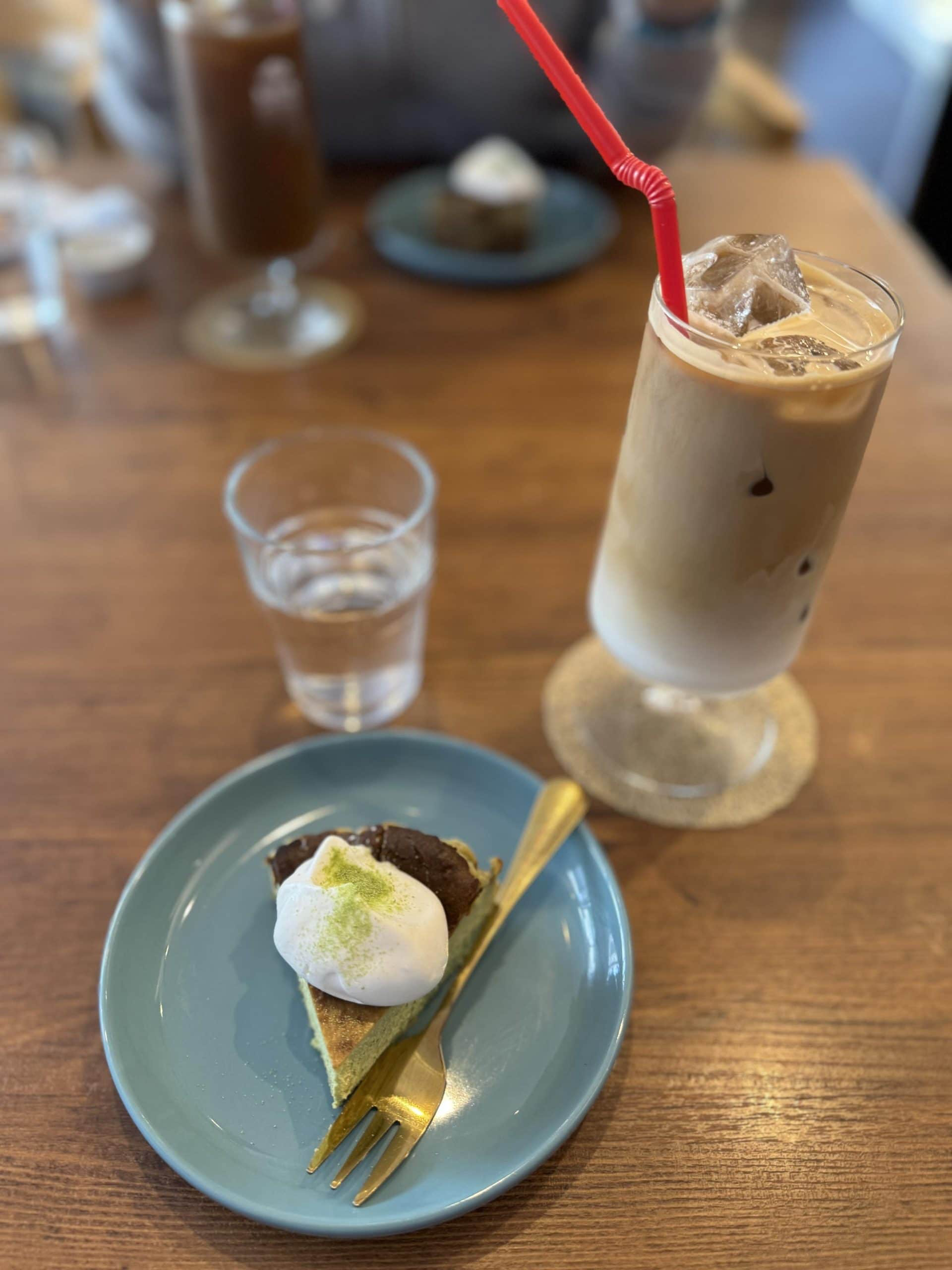 Dessert at "Little Bean Works", a cafe in the Itabashi Ward of Tokyo, Japan. Matcha cheesecake and iced caffe latte. © 2026 Norbert Woehnl Photography.