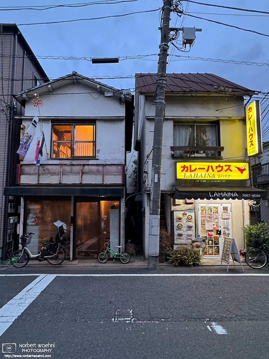 Two buildings in the Azusawa district of Itabashi Ward in Tokyo, Japan. On the right is a Curry Restaurant, on the left is a residential building. © 2026 Norbert Woehnl Photography.