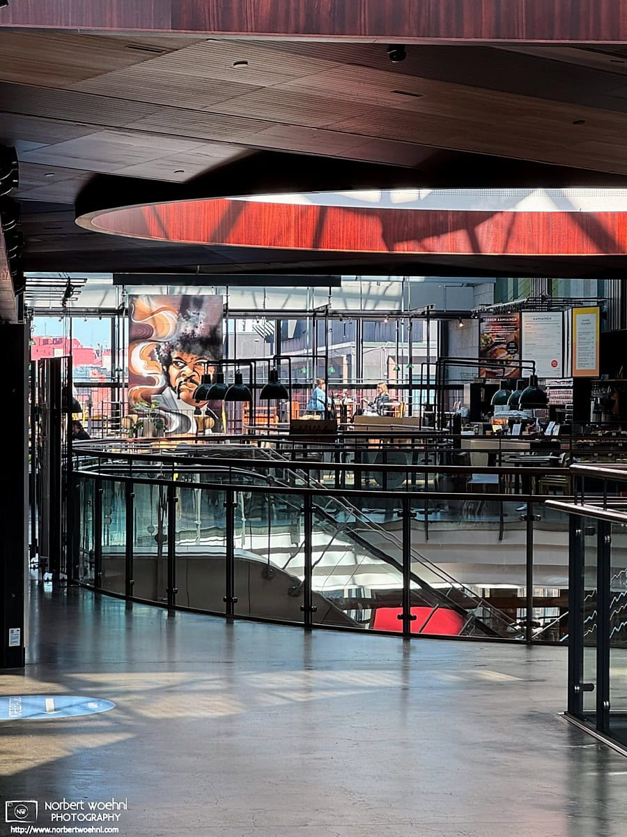 On the top floor of Kamppi Shopping Center in Helsinki, Finland, I saw this poster with a stylized drawing of Samuel L. Jackson hung in a restaurant window. © 2026 Norbert Woehnl Photography.