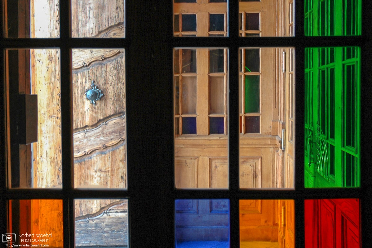 The stained-glass windows around the entrance of Mariatrost Basilica in Graz, Austria, evoke similarities to the work of painter Piet Mondriaan. © 2004 Norbert Woehnl Photography.