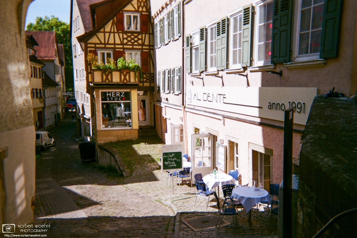 This view into the eastern part of Bursagasse in the historic city center of Tübingen, Germany, shows how the medieval buildings are still being put to use - in this case as shops and restaurants. © 2018 Norbert Woehnl Photography.