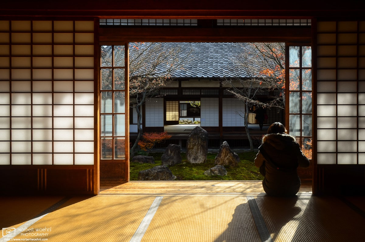 At Kenninji Temple in Kyoto, Japan, a woman is seated on a tatami floor while sunlight is entering the room through the opened sliding doors. © 2012 Norbert Woehnl Photography.