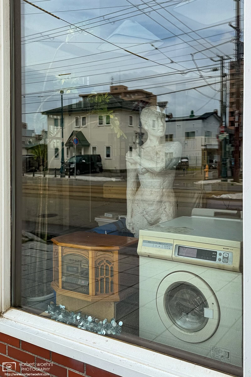 View through the shop window of a used-goods store in the Motomachi area of Hakodate, Japan. © 2025 Norbert Woehnl Photography.