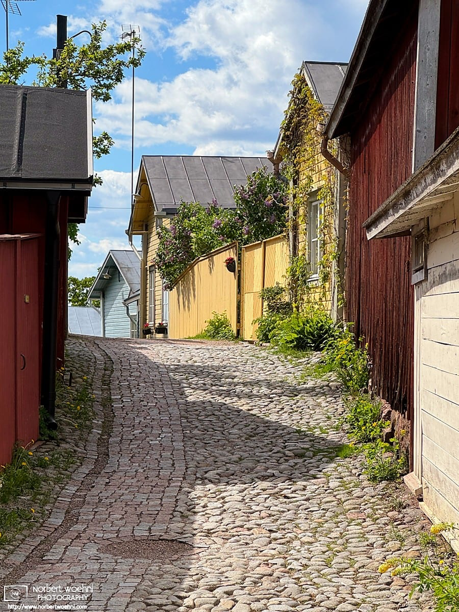 Another lane of colorful wooden buildings in the historic district of Porvoo, Finland. © 2026 Norbert Woehnl Photography.