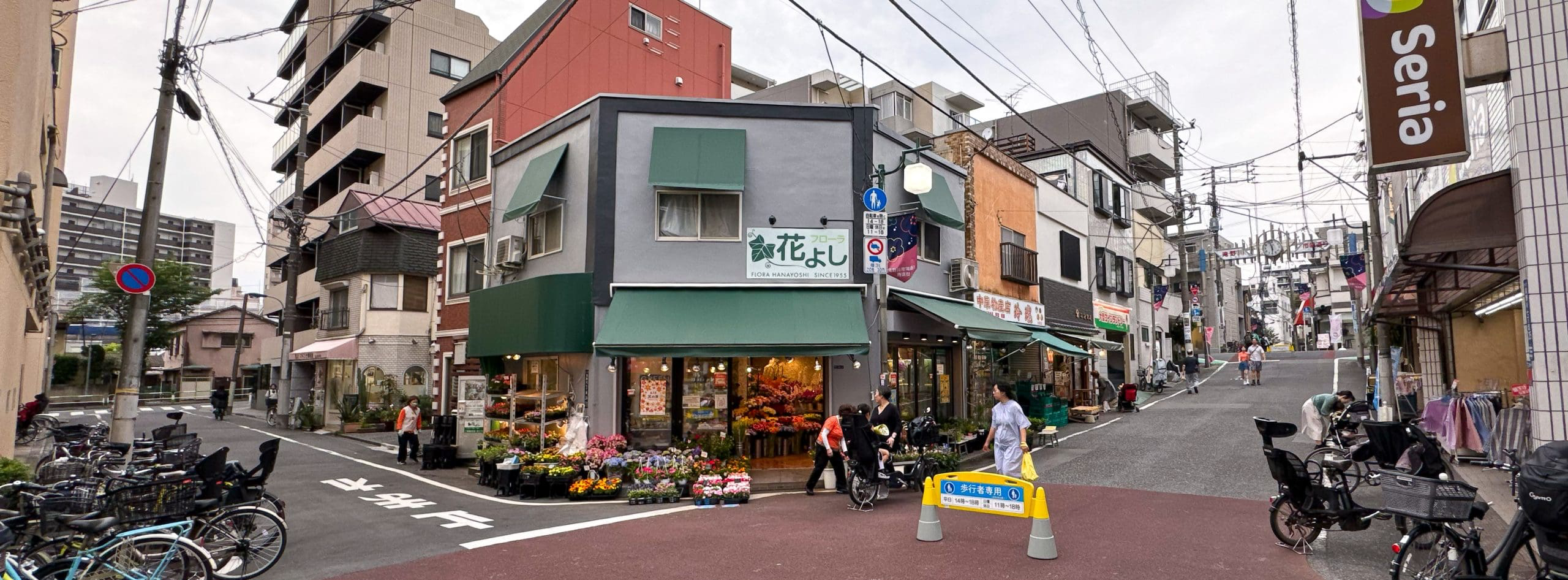 Corner scene at a neighborhood shopping street in the Takinogawa area of Kita Ward in Tokyo, Japan. © 2025 Norbert Woehnl Photography.