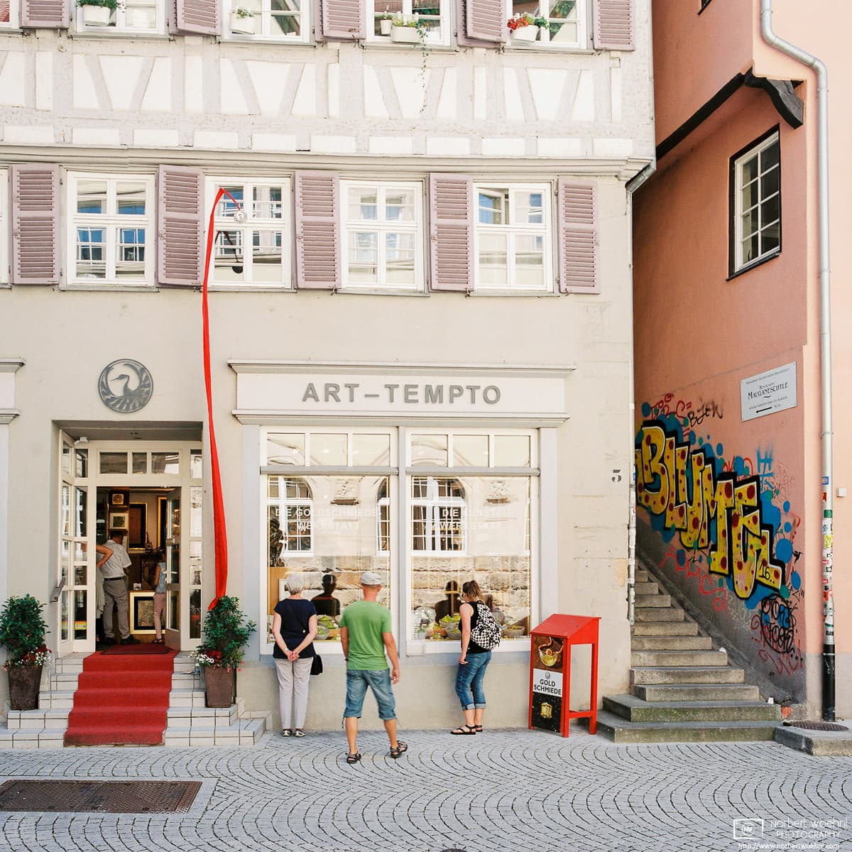 People are looking at the windows of an antiques shop at Haaggasse in the historic city center of Tübingen, Germany. © 2017 Norbert Woehnl Photography.