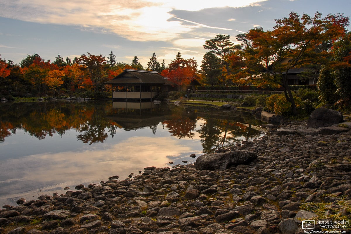 At Showa Memorial Park in Tachikawa, Tokyo, a pond provides a calm seasonal reflection of trees and Japanese-style buildings. © 2006 Norbert Woehnl Photography.