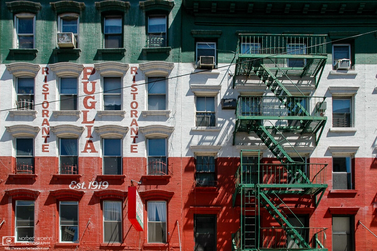 In Little Italy, New York City, a building is painted in the colors of the Italian flag, with even the fire escape stairs matching the green color. © 2005 Norbert Woehnl Photography.