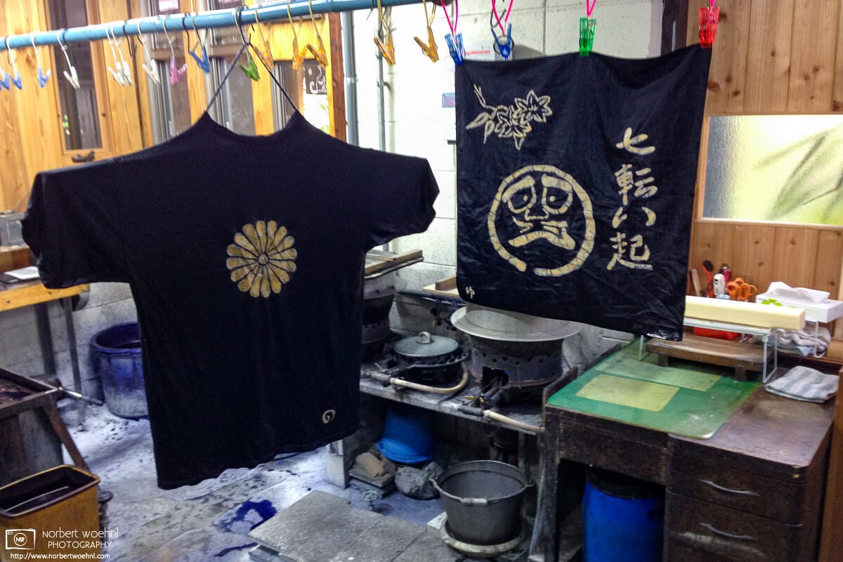 Wax-resist indigo-colored textile items are hung out to dry at a traditional indigo-dyeing shop in Kyoto, Japan. © 2014 Norbert Woehnl Photography.