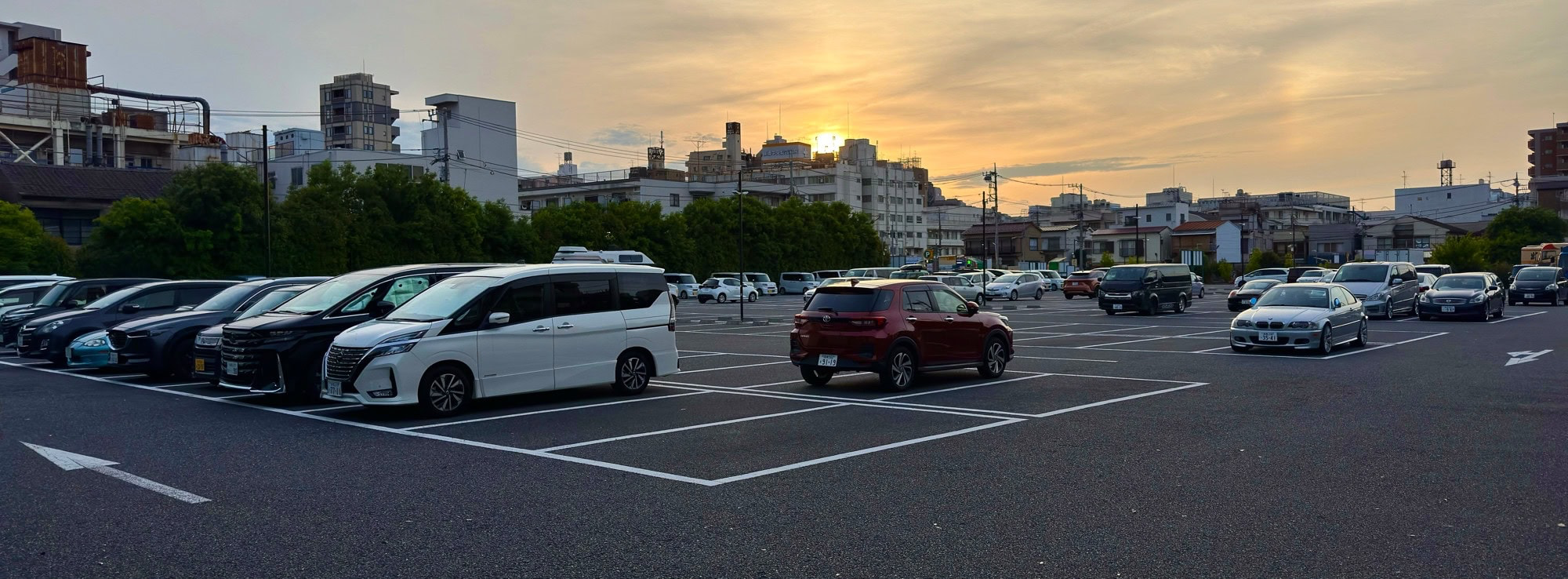 When I got home from the office yesterday evening, I noticed the sun setting behind a parking lot in my neighborhood in the Itabashi Ward of Tokyo, Japan. © 2025 Norbert Woehnl Photography.