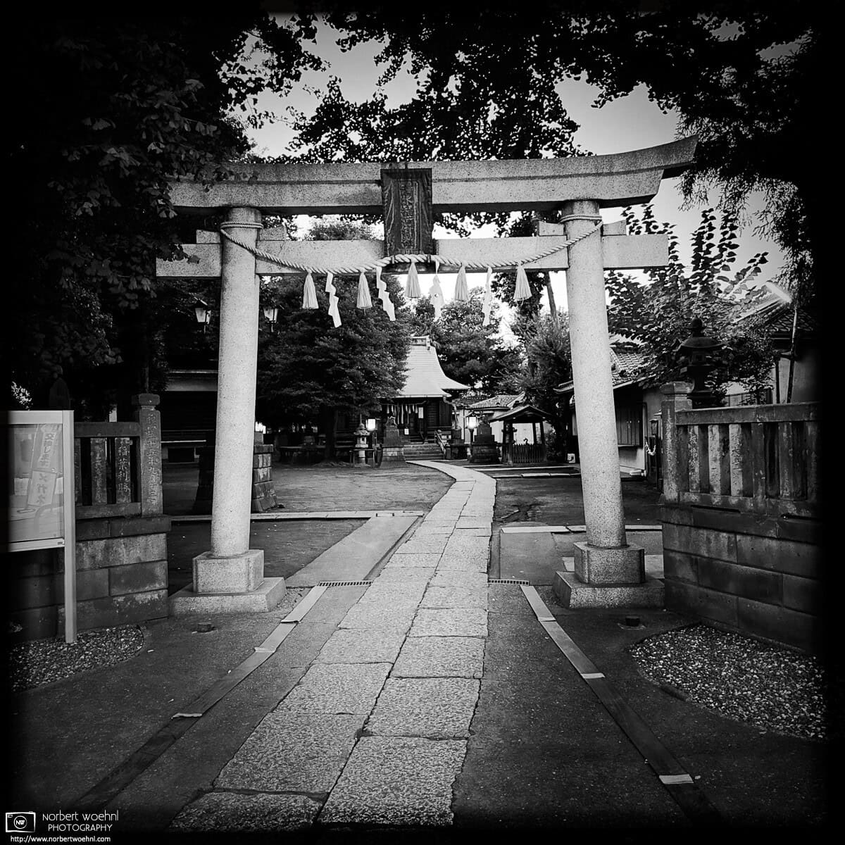 Monochrome evening scene from Shimizu Inari Shrine in the Miyamotocho area of Itabashi Ward in Tokyo, Japan. © 2025 Norbert Woehnl Photography.