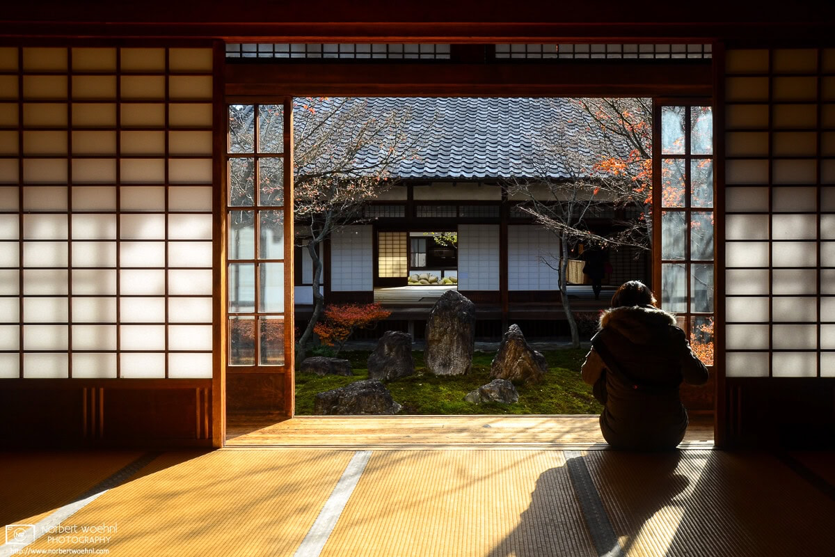 At Kenninji Temple in Kyoto, Japan, a woman is seated on a tatami floor while sunlight is entering the room through the opened sliding doors. © 2012 Norbert Woehnl Photography.