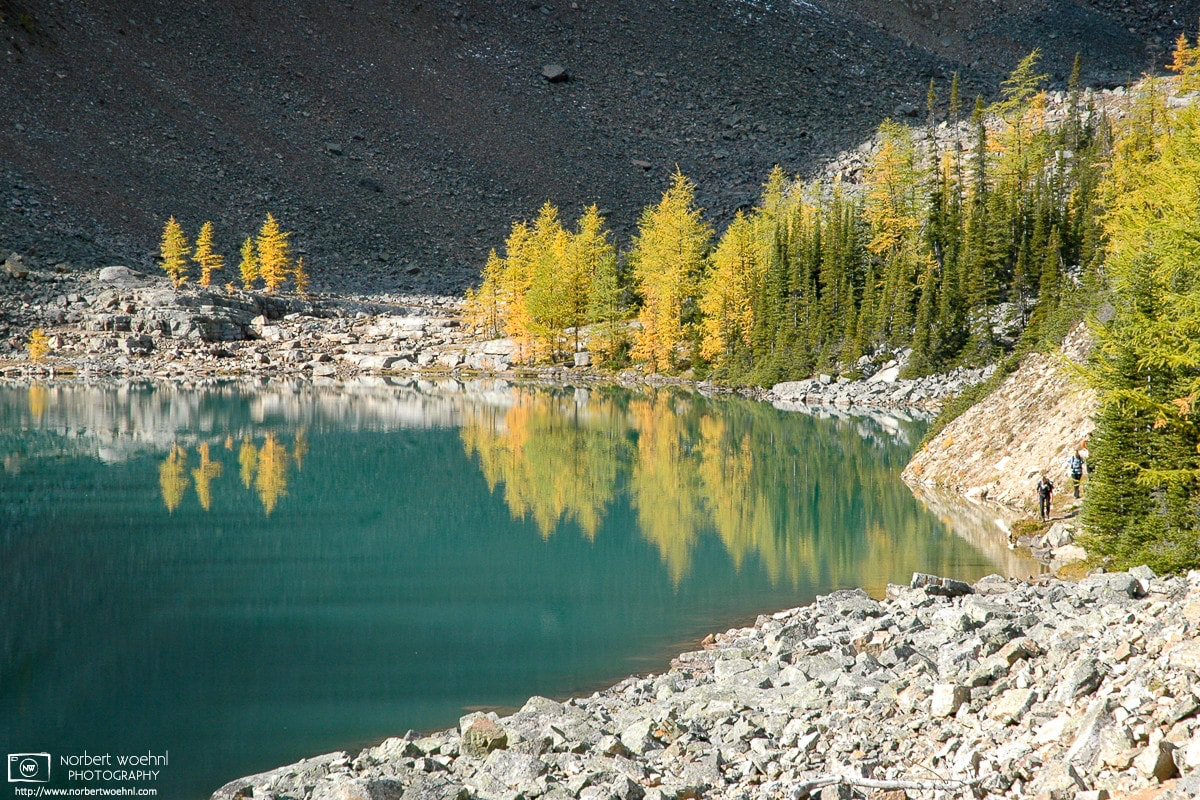 An early touch of autumn colors is being reflected off the surface of Lake Agnes in Banff National Park, Alberta, Canada. © 2005 Norbert Woehnl Photography.