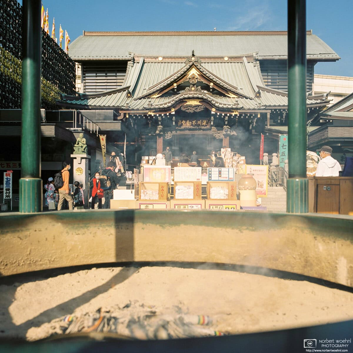 Fukagawa Fudodo is a Tokyo branch of Naritasan Shinshoji Temple in Narita, Chiba Prefecture. This photo looks at its former main hall through an incense burner. © 2021 Norbert Woehnl Photography.