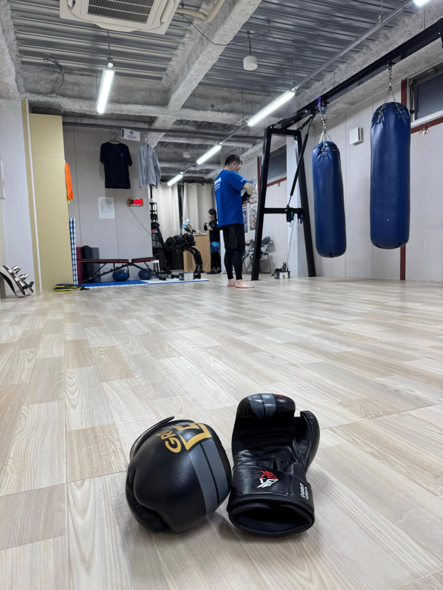 Low attendance level at the kickboxing gym - just one other member was working out during the hour I spent there (the second person in the image is the coach). © 2025 Norbert Woehnl Photography.