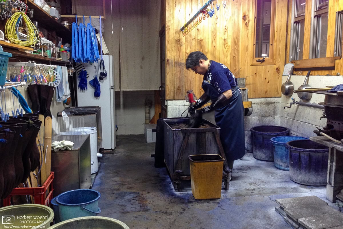 Textile items are being given a soaking in indigo color at a traditional indigo-dyeing shop in Kyoto, Japan. © 2014 Norbert Woehnl Photography.