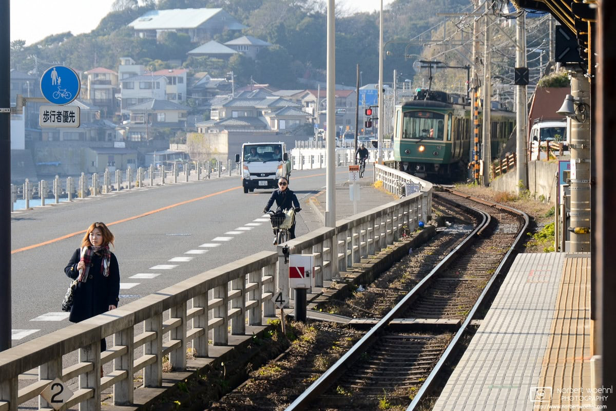 An Enoden (Enoshima Electric Railway) Train is approaching Kamakurakokomae Station in Kanagawa Prefecture. Sections of the line run close to the Shonan Coast. © 2012 Norbert Woehnl Photography.
