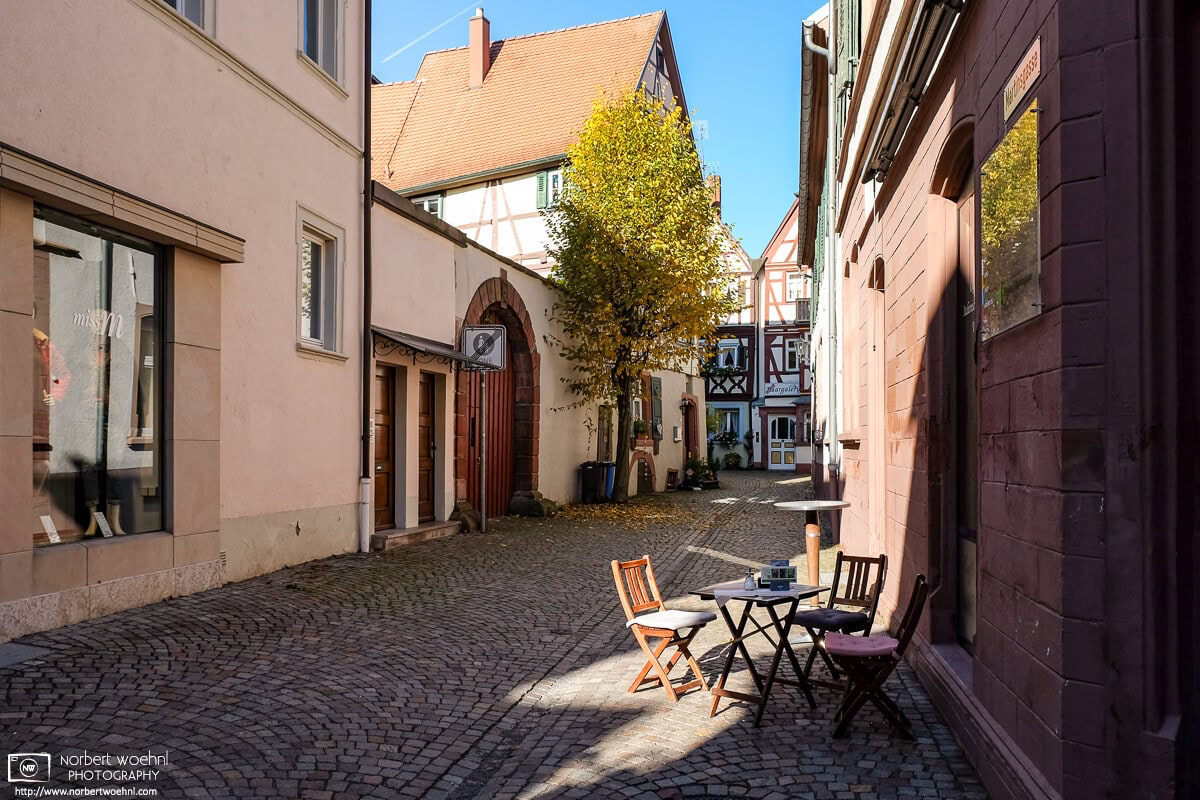 A street cafe table on a quiet side street in the historic city center of Tauberbischofsheim in the southwest-German state of Baden-Württemberg. © 2016 Norbert Woehnl Photography.