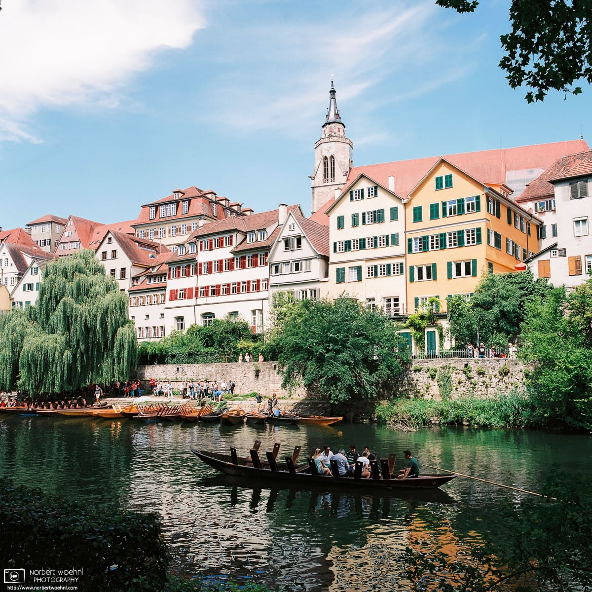 The Neckar waterfront in Tübingen, Germany, features a view of some of the oldest buildings in the city. During the summer months, Stocherkahn boats navigated by long wooden poles are operating on the river. © 2017 Norbert Woehnl Photography.