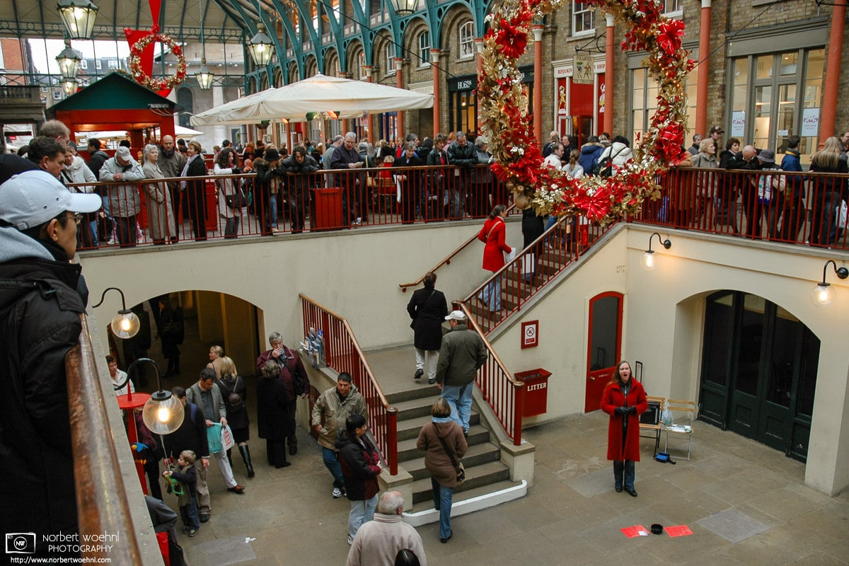 A woman is singing Christmas songs at Covent Garden in London, England. © 2004 Norbert Woehnl Photography.