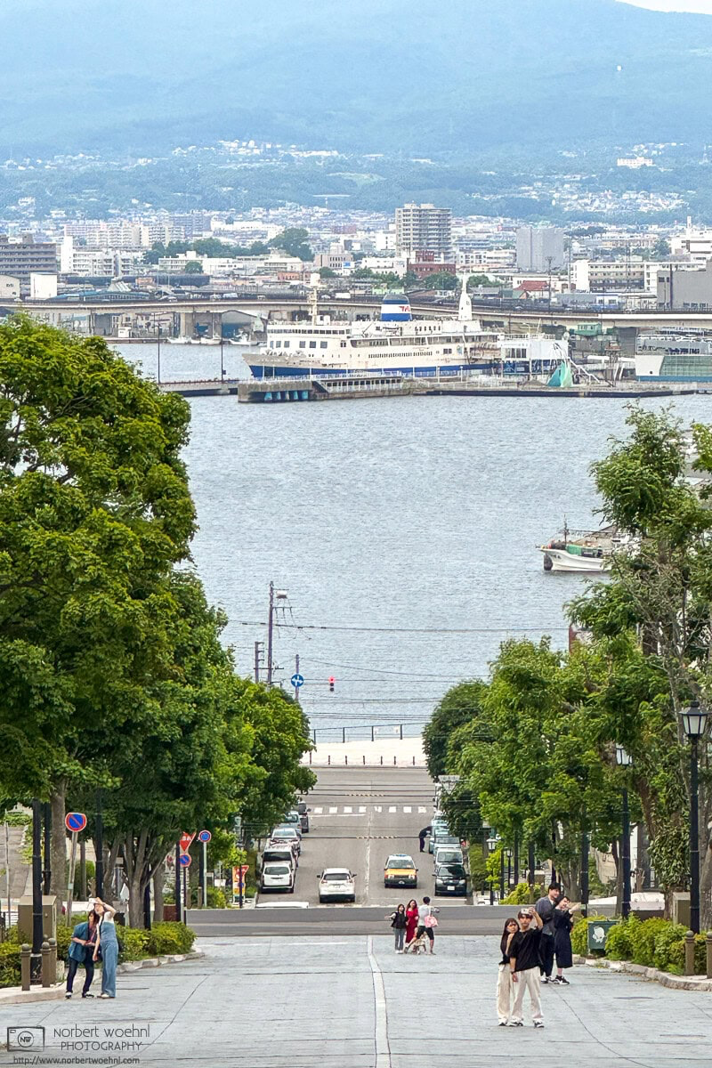 View down Hachiman-zaka Slope in Hakodate, Japan, towards the ocean and Hakodate Port. © 2025 Norbert Woehnl Photography.