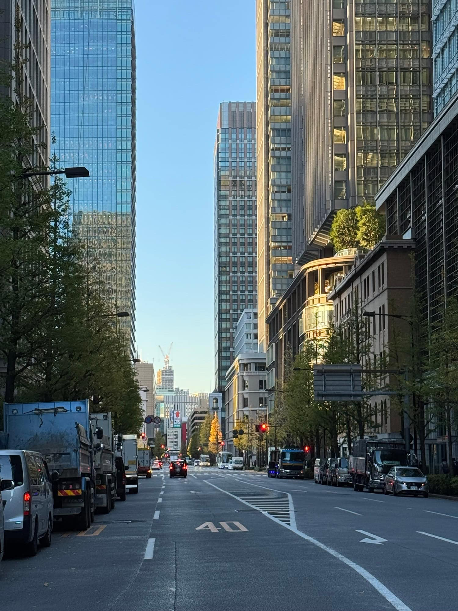December morning sunlight and a few autumn colors amidst high-rise office buildings in the Marunouchi/Otemachi area of Tokyo, Japan. © 2025 Norbert Woehnl Photography.