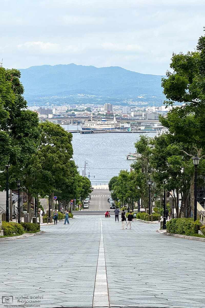 View down Hachiman-zaka Slope in Hakodate, Japan, towards the ocean and Hakodate Port. © 2025 Norbert Woehnl Photography.