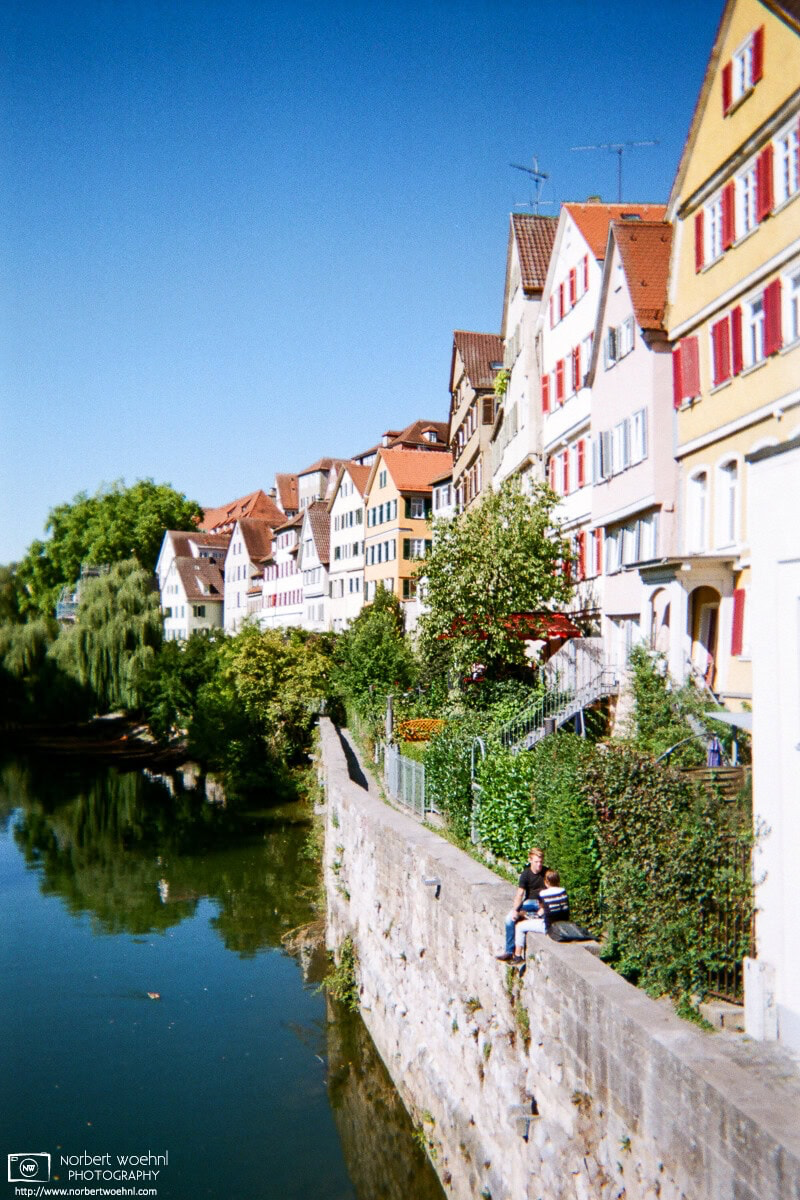 The Neckar embankment in Tübingen, Germany, features a view of some of the oldest buildings in the city, as well as seating opportunities with a pretty steep drop. © 2018 Norbert Woehnl Photography.