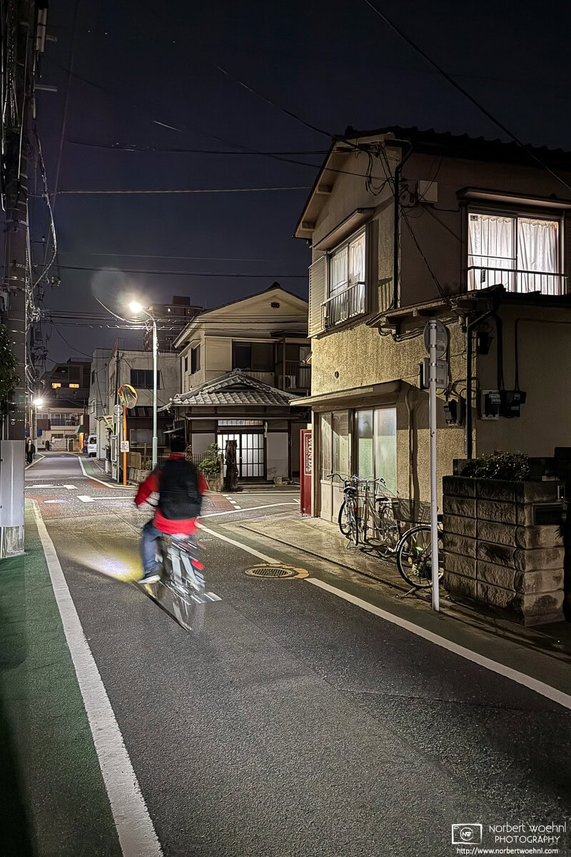 Bicyclist riding on a backstreet in the Hasunumacho district of Itabashi Ward in Tokyo, Japan. © 2026 Norbert Woehnl Photography.