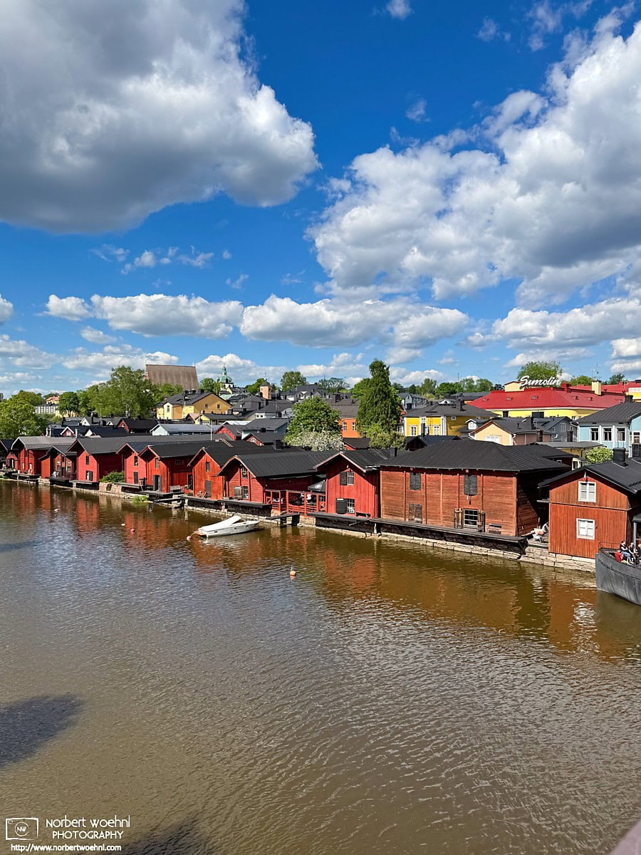 View of historic red warehouses along the Porvoonjoki River in Porvoo, Finland. © 2026 Norbert Woehnl Photography.
