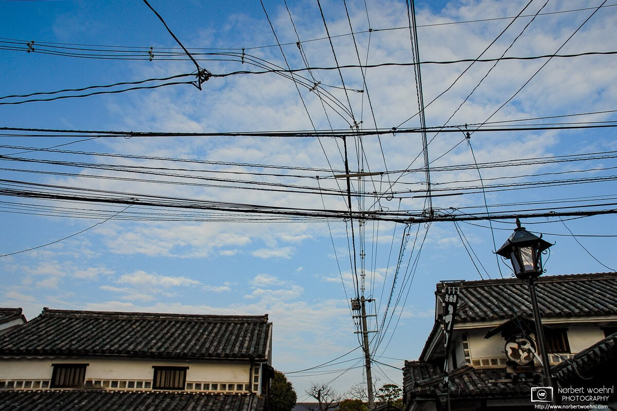 Looking up in the historic Bikan district of Kurashiki in Okayama Prefecture, Japan, I noticed this rather elaborate mesh of electric cables and wires. © 2006 Norbert Woehnl Photography.