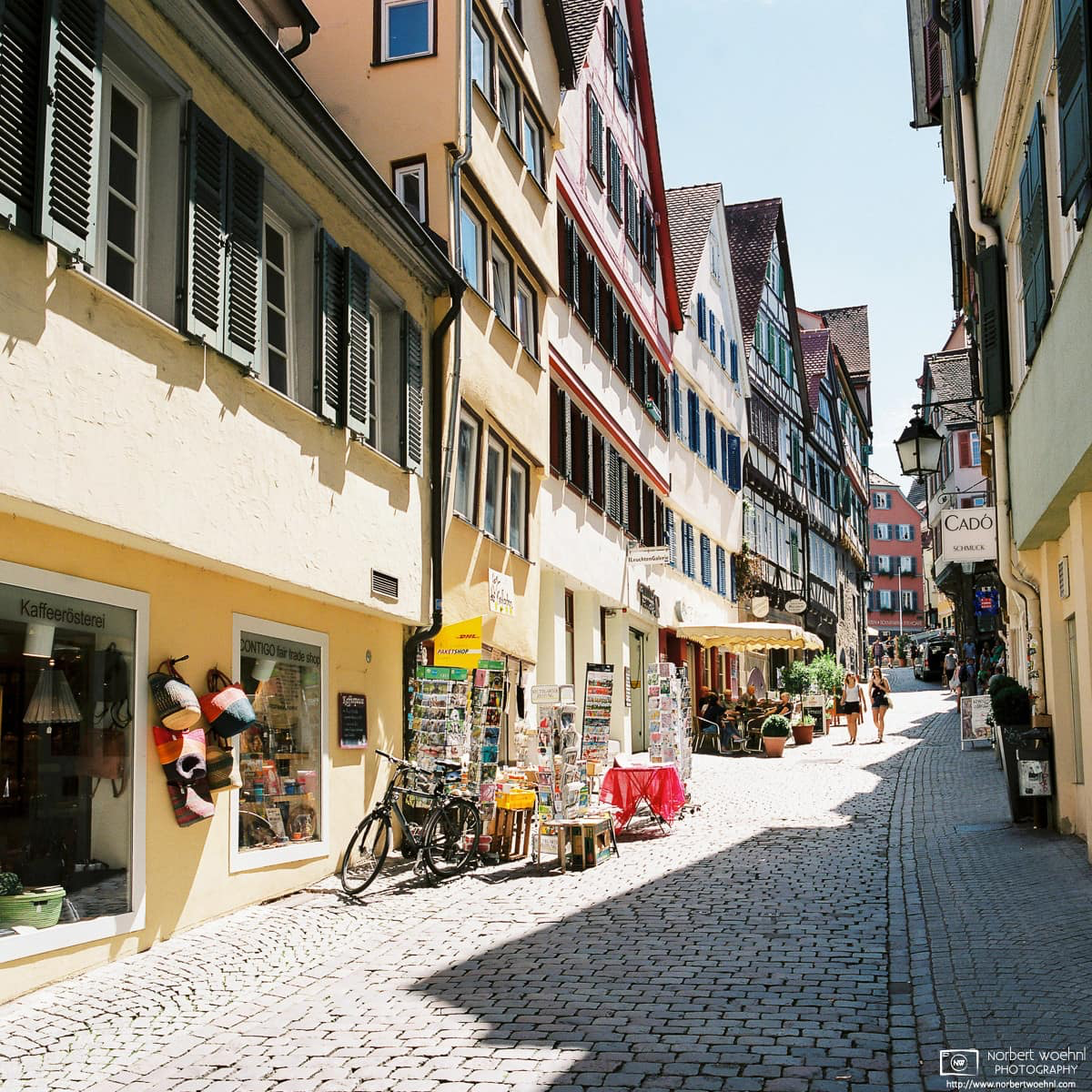 Marktgasse in Tübingen, Germany, is one of the city's many cobblestone roads lined with shops and restaurants in beautifully kept medieval buildings. © 2017 Norbert Woehnl Photography.