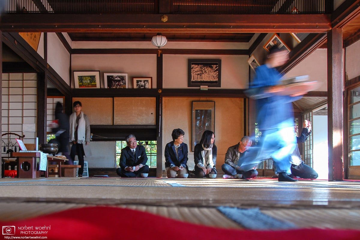 At Hosen-in Temple in Ohara, northern Kyoto, temple staff is moving through a room to bring tea and sweets to visitors seated on the outside patio. © 2010 Norbert Woehnl Photography.