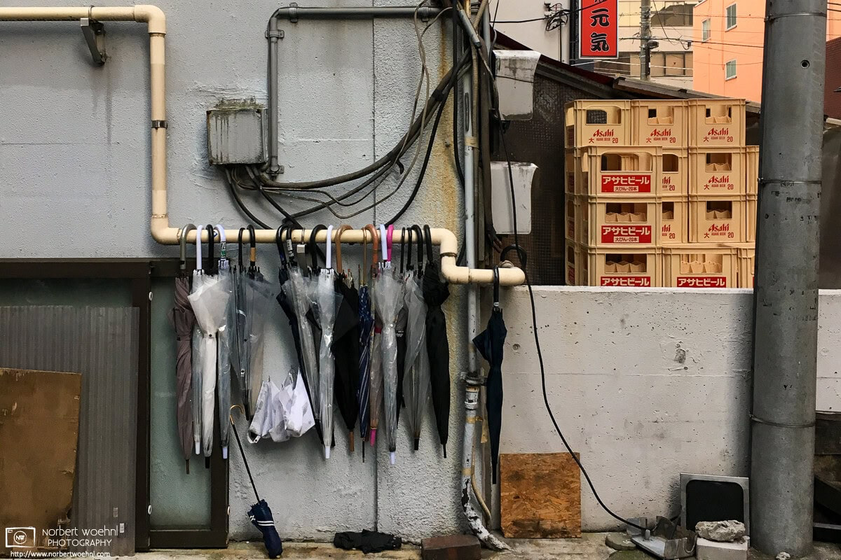 A still life of umbrellas and beer crates in the Taito Ward of Tokyo, Japan. Taken on a photo walk in 2018 with photographer Alfie Goodrich. © 2018 Norbert Woehnl Photography.