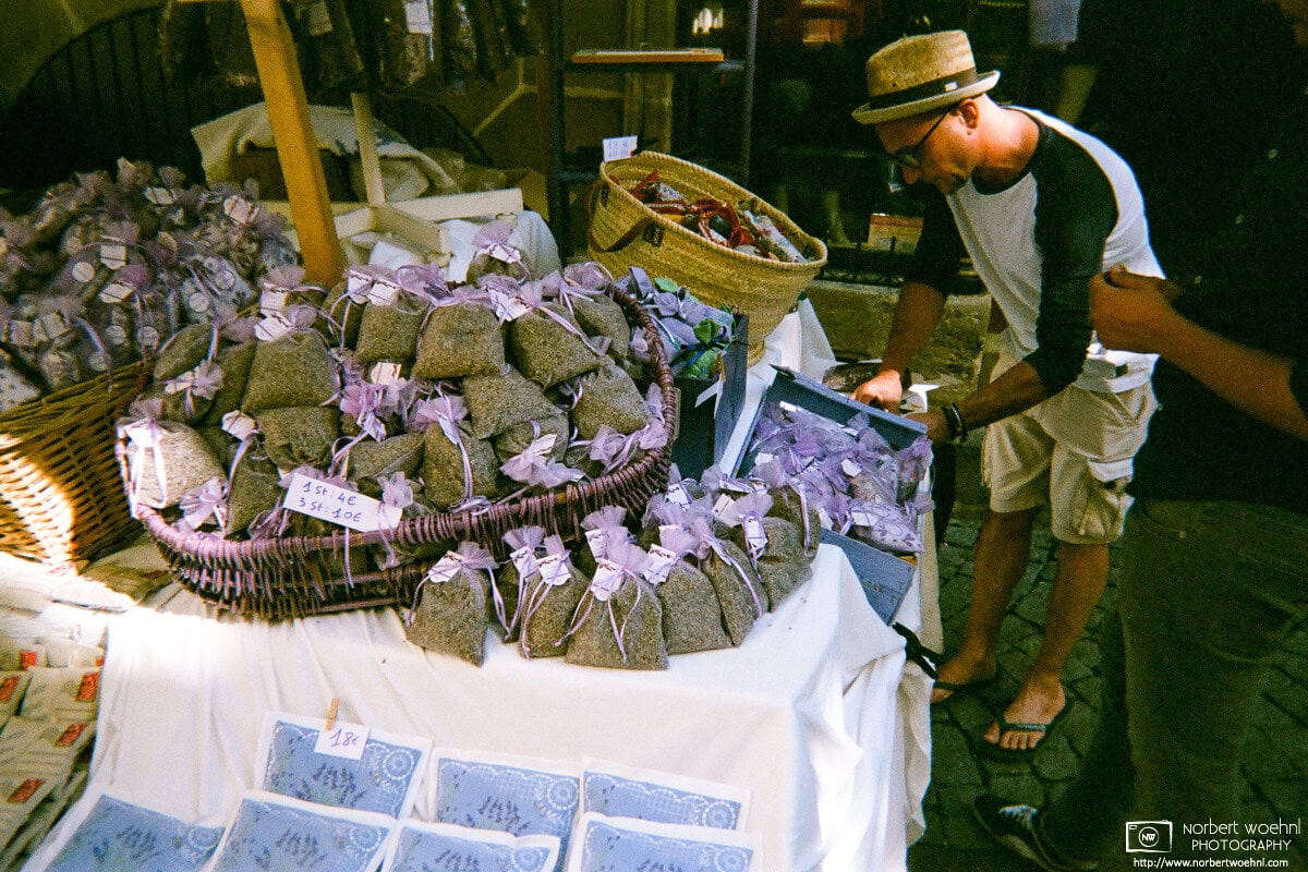 During a French-style market event in the city of Tübingen, Germany, a vendor is selling lavender products. © 2018 Norbert Woehnl Photography.