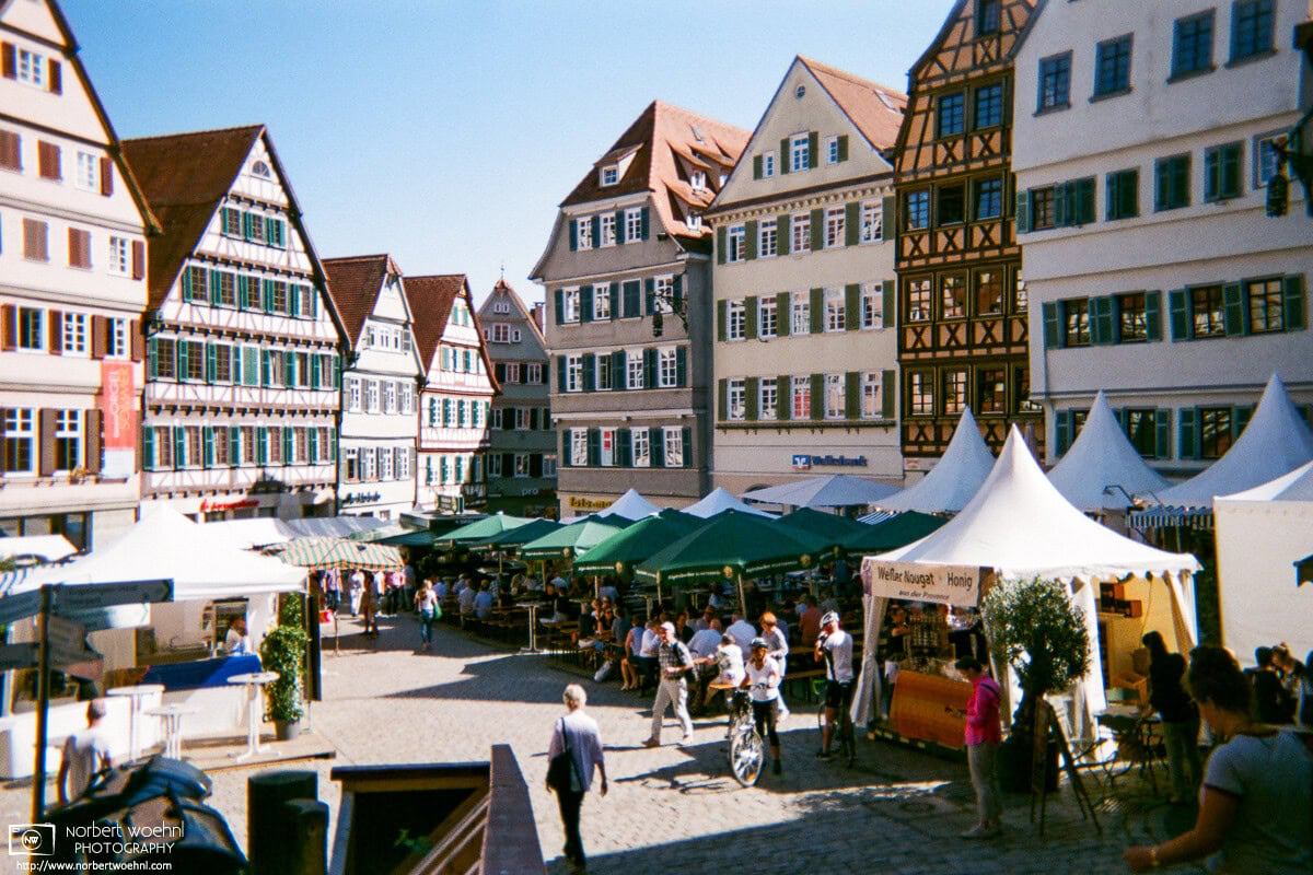 Scene from the historic market square of Tübingen, Germany, with rows of beautifully kept old buildings delineating the spacious and inviting setting. © 2018 Norbert Woehnl Photography.